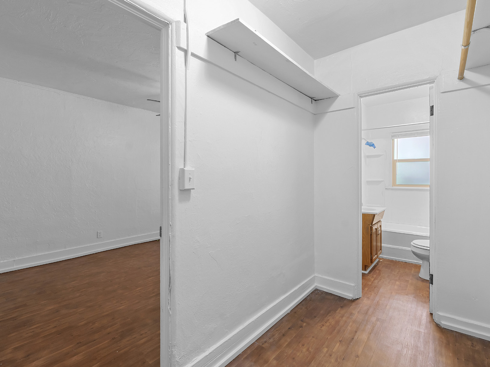 Bathroom with white vanity, sink, and shower curtain