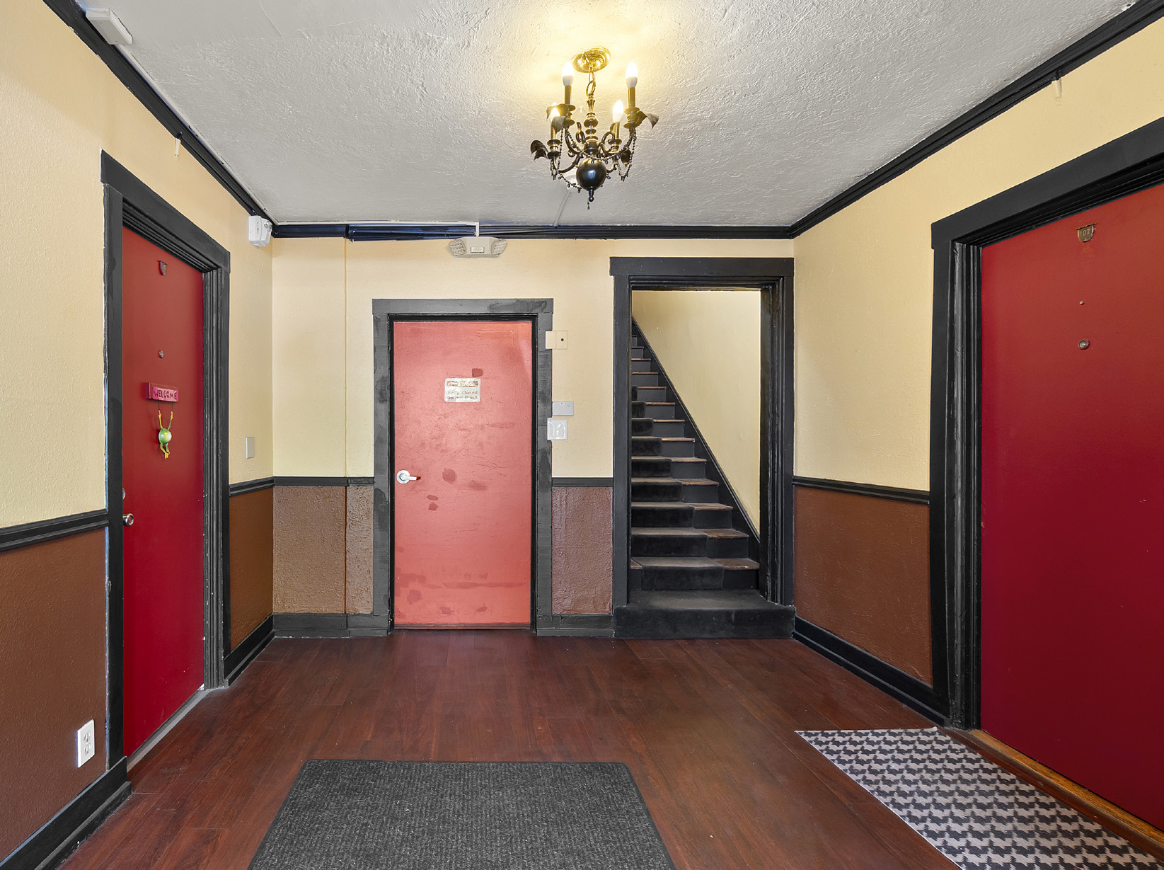 Entryway with red doors and staircase