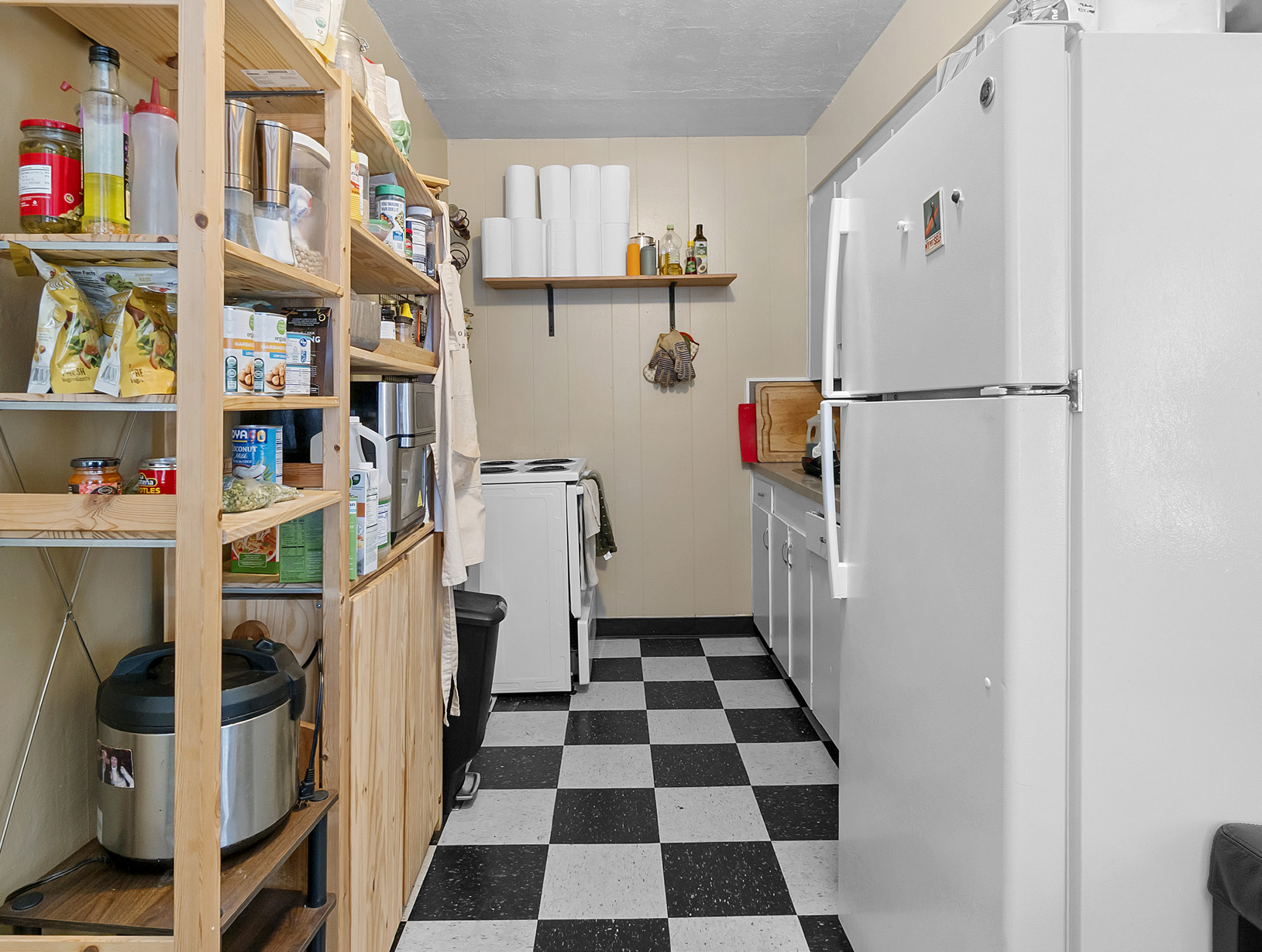 Kitchen with pantry shelving and checkered floor