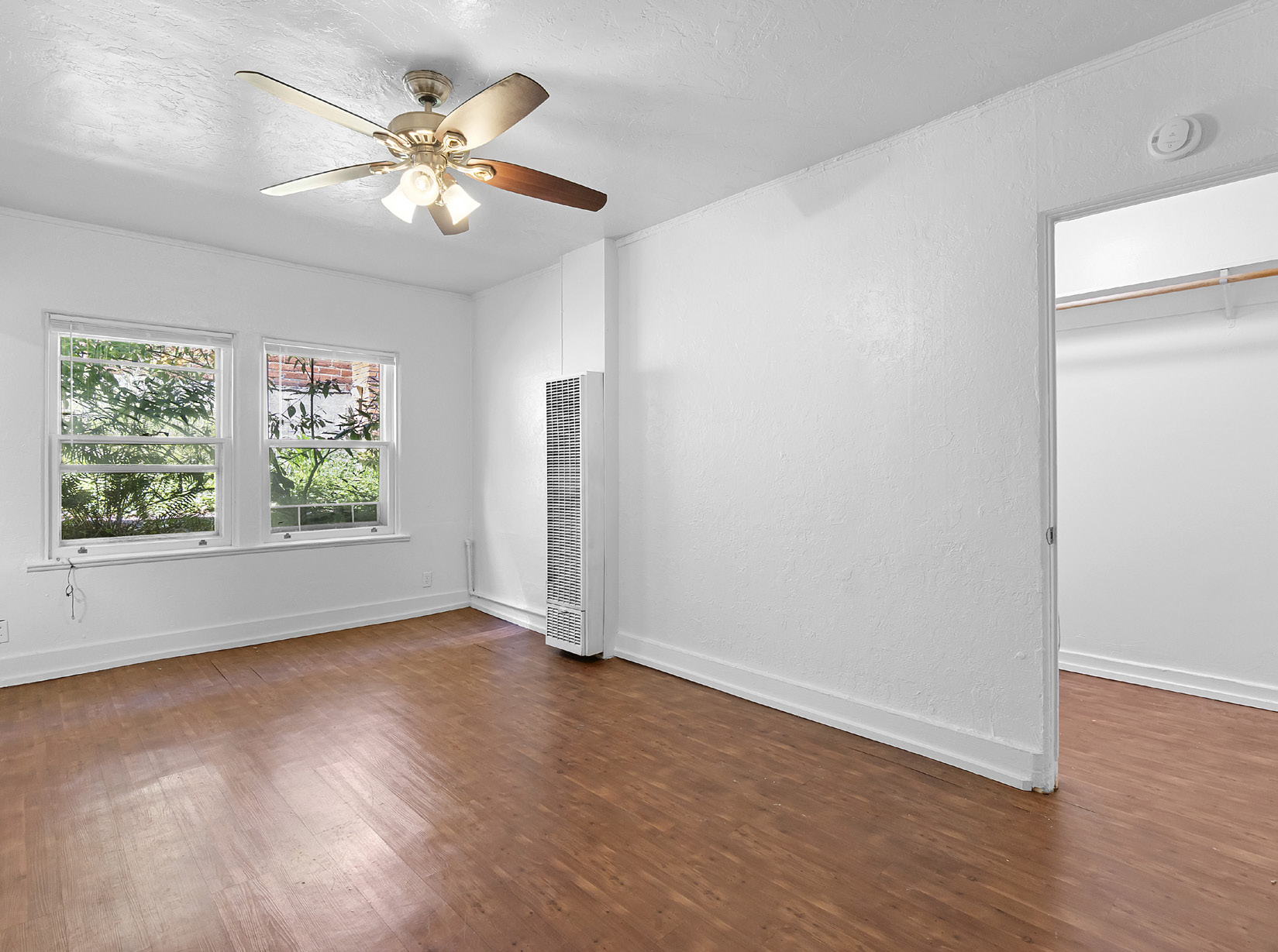Living room with ceiling fan and hardwood floors