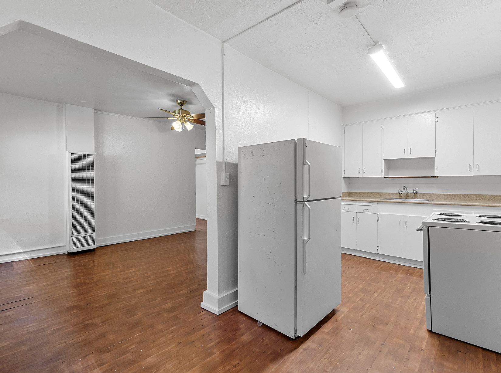 Kitchen and living area with hardwood floors